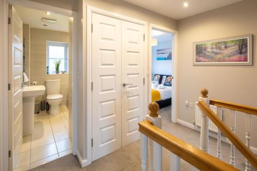 a bathroom with a door leading to a bedroom at Beautiful & Luxurious Home - Free Parking, Wi-Fi in Heywood
