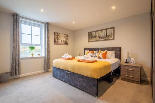 a bedroom with a large bed and a window at Beautiful & Luxurious Home - Free Parking, Wi-Fi in Heywood