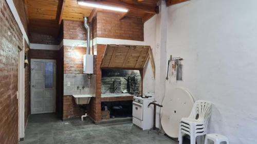 a kitchen with a sink and a stove at Sonidos del Mar in Balneario El Condor