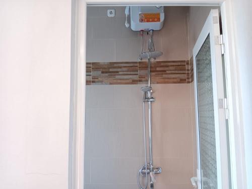 a shower stall in a bathroom with a shower at Pengok Kidul 21 in Demangan