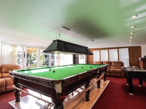 a pool table in a living room with a ceiling at The Secret Garden at Old Drynie House in Inverness