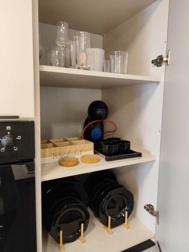 a cupboard with some pans and other items in it at Sea Stars 2 APARTMENT in Perea