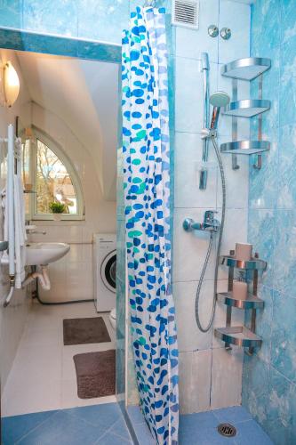 a bathroom with a shower with a glass door at Апартаменти Дача in Varna City