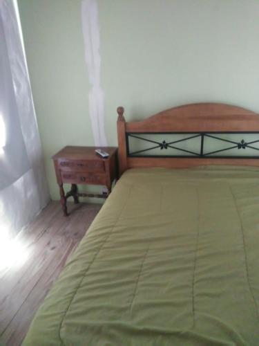 sypialnia z łóżkiem i stolikiem w obiekcie Casa Rosa w mieście Balneario Claromecó