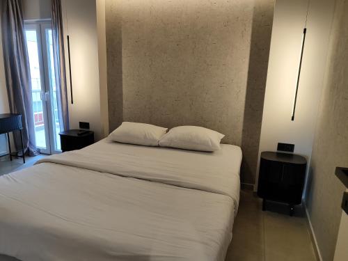a bedroom with a bed with two pillows on it at Sea Stars 2 APARTMENT in Perea