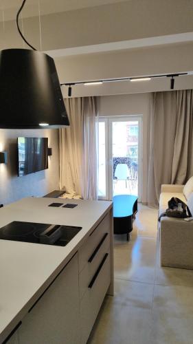 a kitchen with a stove top oven in a room at Sea Stars 2 APARTMENT in Perea
