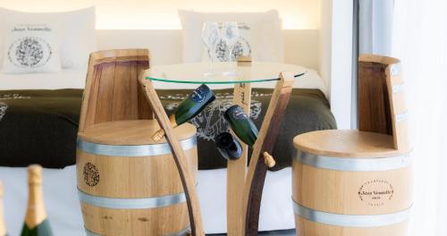 two wooden stools with a table and two wine barrels at CUVEE J2 HOTEL OSAKA by Onko Chishin in Osaka