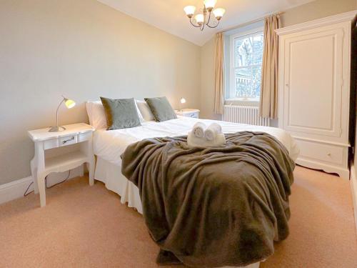 a bedroom with a bed with two towels on it at 4 Studio House in Ambleside