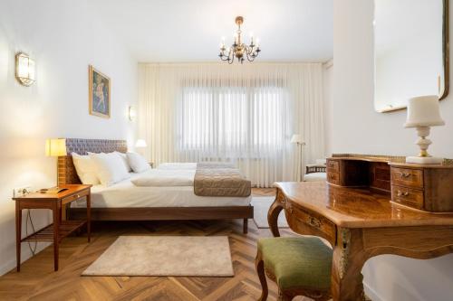 a bedroom with a bed and a desk and a desk at Nobel Boutique in Bucharest