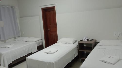 Letto o letti in una camera di HOTEL PLAZA PONTES e LACERDA