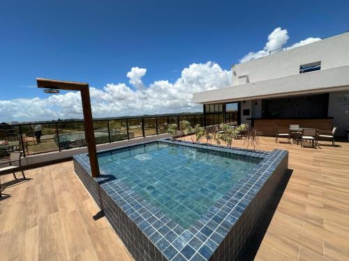 a swimming pool on the roof of a house at Pousada Atlantic in Porto De Galinhas