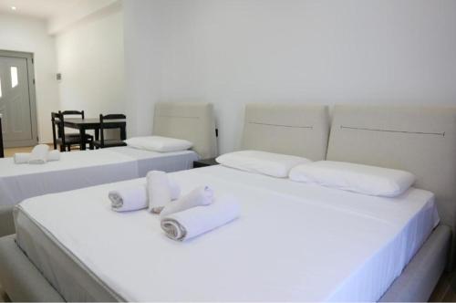 a room with two beds with towels on them at Lux Apartments in Ksamil