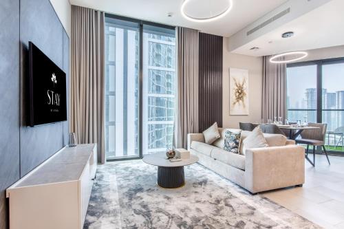 a living room with a couch and a table at STAY BY LATINEM Luxury 2BR Holiday Home W1813 near Burj Khalifa in Dubai