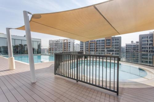 a rooftop deck with a pool on a building at STAY BY LATINEM Luxury 2BR Holiday Home W1813 near Burj Khalifa in Dubai