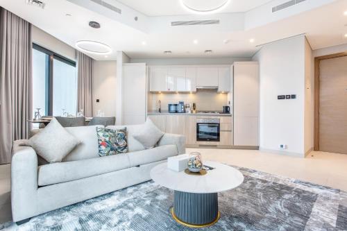 a living room with a couch and a table at STAY BY LATINEM Luxury 2BR Holiday Home W1813 near Burj Khalifa in Dubai