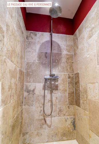 a shower with a shower head in a bathroom at Le Passage in Carcassonne