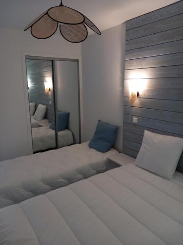 a bedroom with a large bed and a mirror at La Campana 107 in Bielle