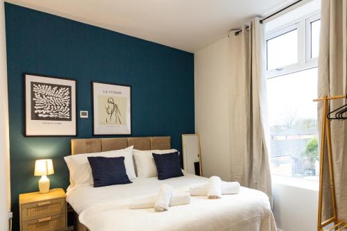 a bedroom with a large bed with blue walls at Suite 5 - Stylist Spot in Oldham City Centre in Oldham