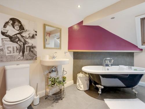 een badkamer met een wastafel, een bad en een toilet bij Pass the Keys Spacious 5 Bed House Sleeps up to 12 in Manchester