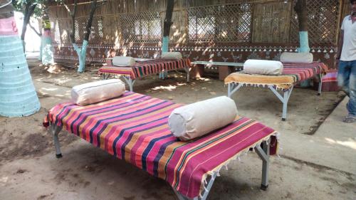 a group of chairs with pillows on top of them at Bendre's Farm Stay-Neral in Neral