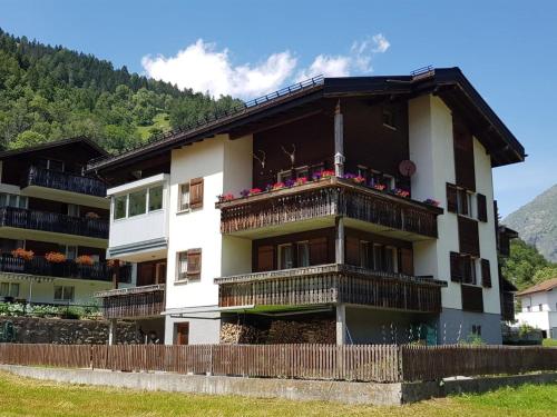 a building with a balcony with flowers on it at Apartment Lischa by Interhome in Fiesch