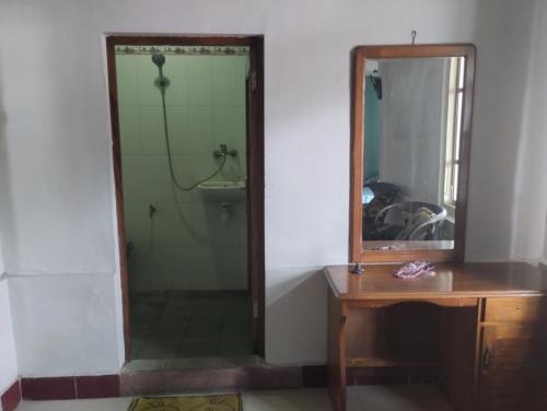 a bathroom with a shower and a mirror and a sink at MATRONA in Bajawa
