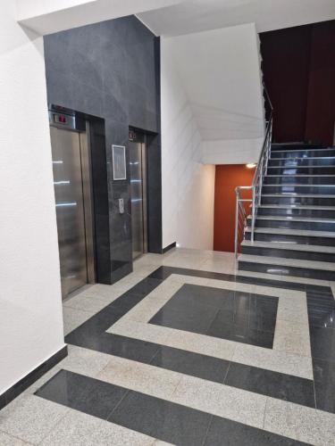 un vestíbulo con escaleras y ascensores en un edificio en Studio App Bulevar - free parking, en Sarajevo