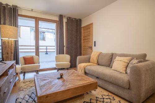 a living room with a couch and a coffee table at Charming three-room apartment in Huez - Welkeys in LʼHuez
