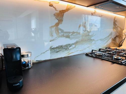 a phone sitting on a counter next to a stove at Balcescu Downtown Apartment in Bistriţa