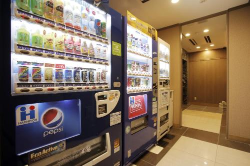 a row of refrigerators in a kitchen at Hotel Sunoak Kashiwanoha in Kashiwa