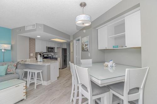 a kitchen and living room with a table and chairs at Immaculate! Beautifully Renovated Oceanfront 1 Bedroom Suite - Sleeps 6! - Roxanne Towers Unit 804 in Myrtle Beach