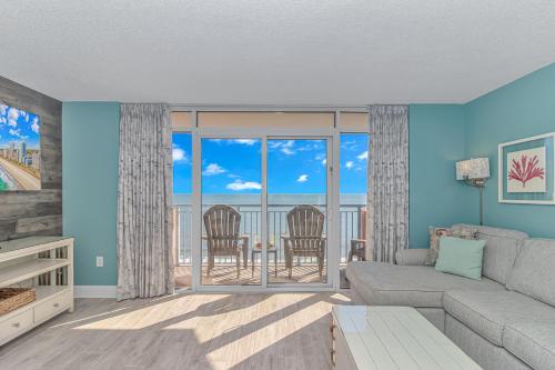 a living room with a couch and views of the ocean at Immaculate! Beautifully Renovated Oceanfront 1 Bedroom Suite - Sleeps 6! - Roxanne Towers Unit 804 in Myrtle Beach