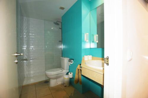 a blue bathroom with a toilet and a sink at Book Jet - Atlantic Dream Apartment & wifi in Corralejo