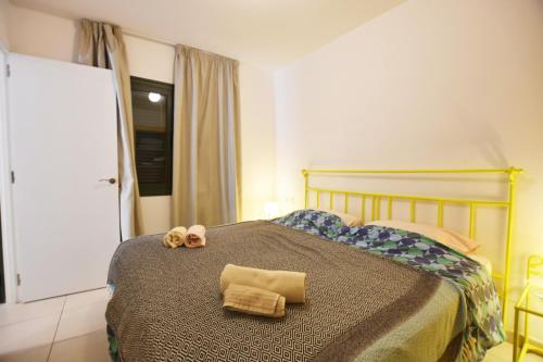 a bedroom with a bed with two towels on it at Book Jet - Atlantic Dream Apartment & wifi in Corralejo
