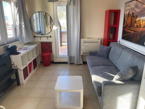 a living room with a couch and a table at Silent Bay Apartments in Sestri Levante