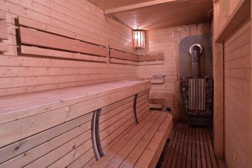 an empty sauna with a bench in a wooden room at Pirtis link Moletu in Vilnius