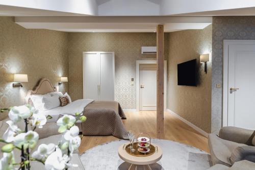 a hotel room with a bed and a living room at Hotel Unicus Palace Old Town - Destigo Hotels in Kraków
