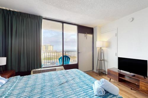 a hotel room with a bed and a large window at Daytona Day Dreamin in Daytona Beach Shores