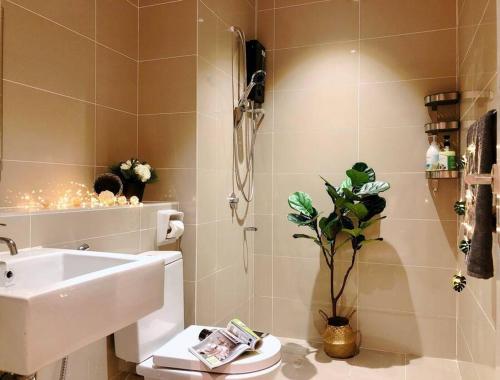 a bathroom with a sink and a toilet at Space Grey / Opposite IMAGO / KK City Center in Kota Kinabalu