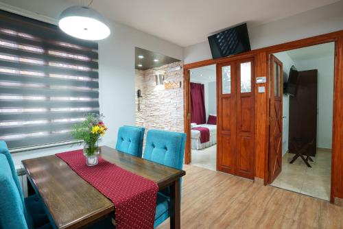 a dining room with a table and blue chairs at Cabañas Tierra Mistica in Ushuaia