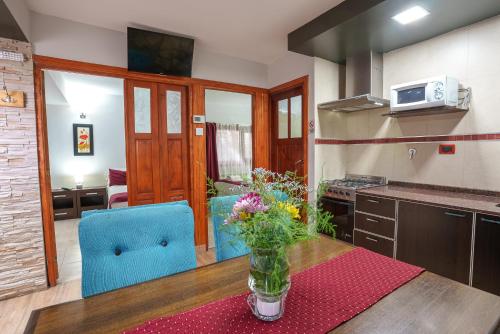 a kitchen with a vase of flowers on a table at Cabañas Tierra Mistica in Ushuaia