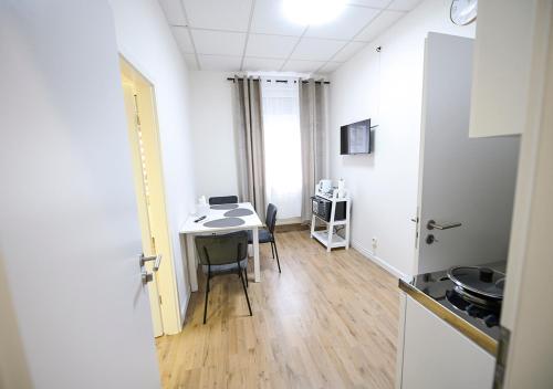 a room with a desk and a table with chairs at GLOW Apartment in Magdeburg