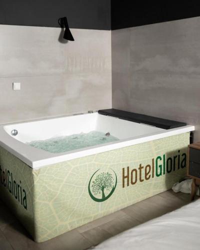 a hot tub sitting on top of a bed at Hotel Gloria KS in Pristina