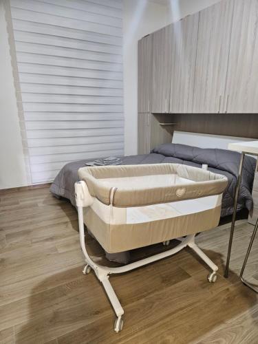 a bed in a bedroom with a wooden floor at B&B DEI SOGNI in centro, con facilità di parcheggio in Cosenza