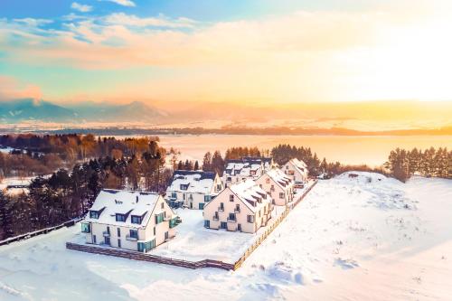a group of houses in the snow on a hill at Rezort Maladinovo pri Liptovskej Mare in Liptovský Mikuláš