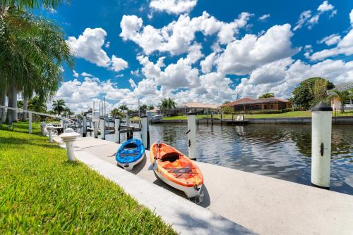 two boats are docked at a dock on a river at Villa Hibiscus-Waterfront-Punta Gorda FL in Punta Gorda