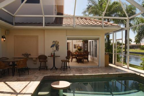 a house with a swimming pool and a patio at Villa Hibiscus-Waterfront-Punta Gorda FL in Punta Gorda