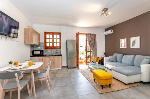 a living room with a couch and a table at Kos Infinity Suites in Kos Town