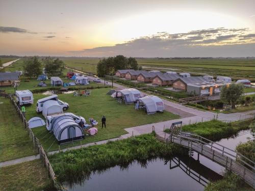 an aerial view of a group of tents next to a river at Camping De Boerinn in Kamerik