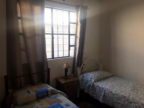 a bedroom with two beds and a window at La casa de la abuela in Rivera